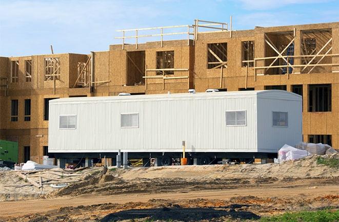 workers studying blueprints in a temporary rental office in Fort Pierce